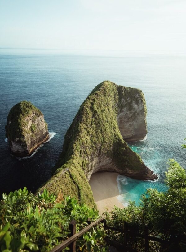 a couple of large rocks sitting on top of a lush green hillside