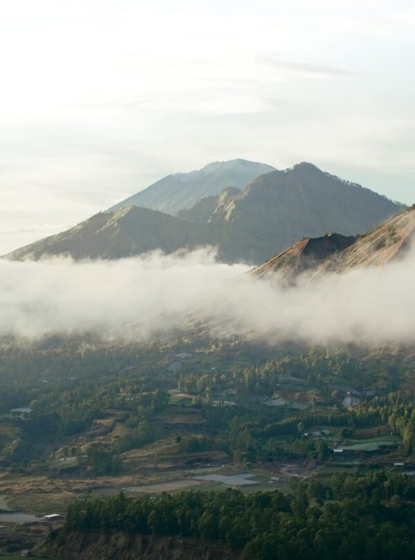 a valley with a town in it and mountains in the back