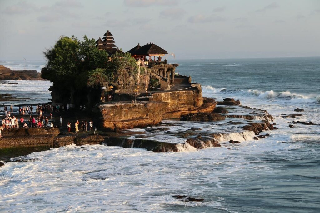 Breathtaking view of Tanah Lot Temple on the rocky coast of Bali, Indonesia, during sunset.