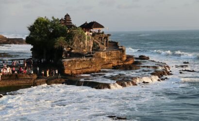 Breathtaking view of Tanah Lot Temple on the rocky coast of Bali, Indonesia, during sunset.
