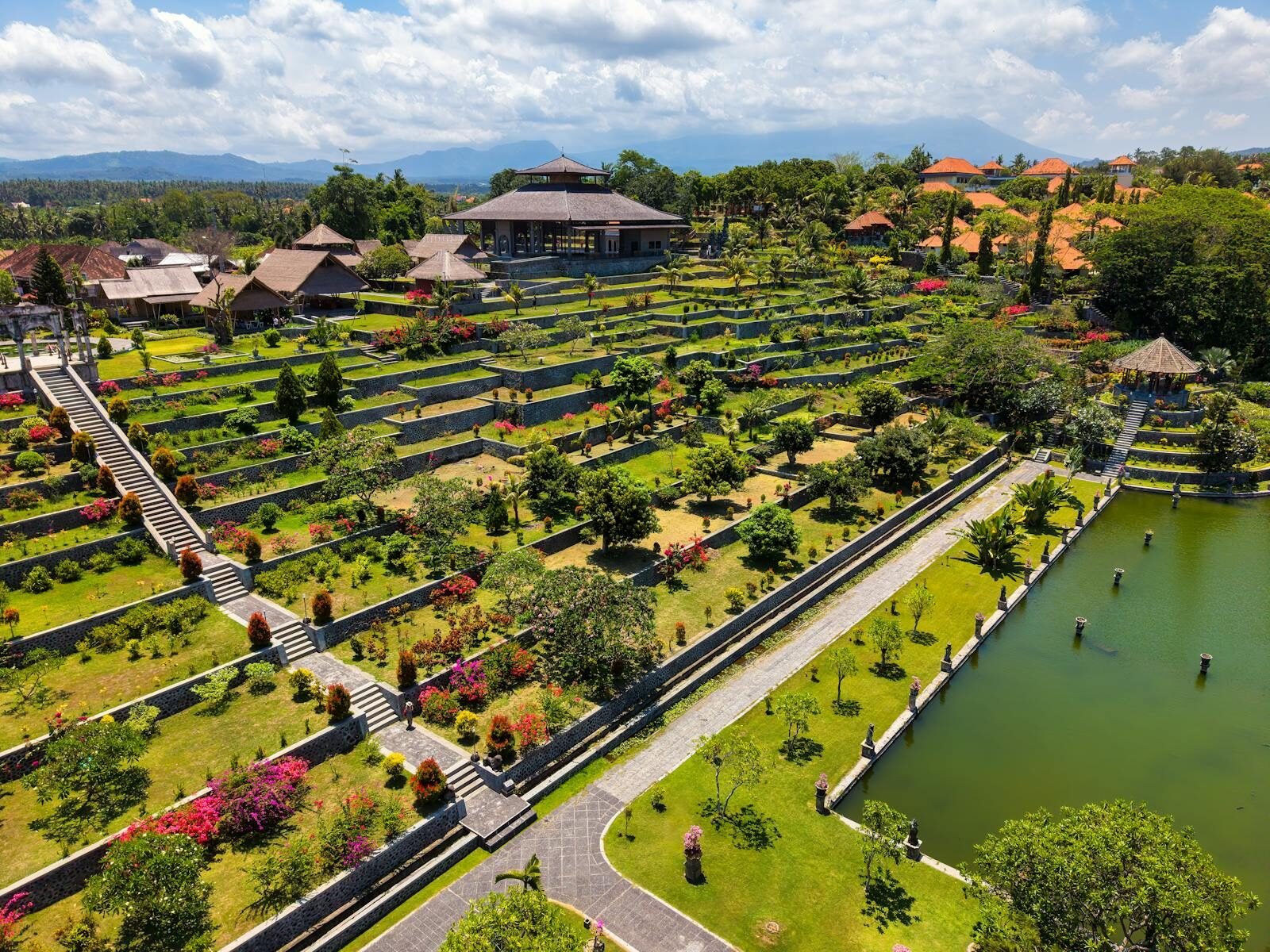 Discover the stunning terraces and lush greenery of Tirta Gangga Water Palace in Bali, Indonesia.