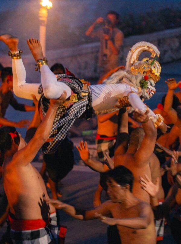 Dancers perform a traditional ritual with torches at night.