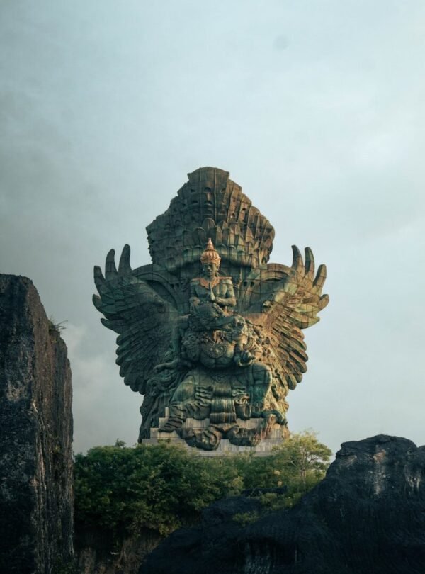 A large statue of a god on top of a mountain