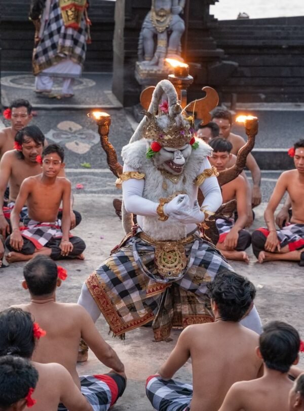 A vibrant traditional Kecak dance performed outdoors in Bali with dancers in cultural attire.