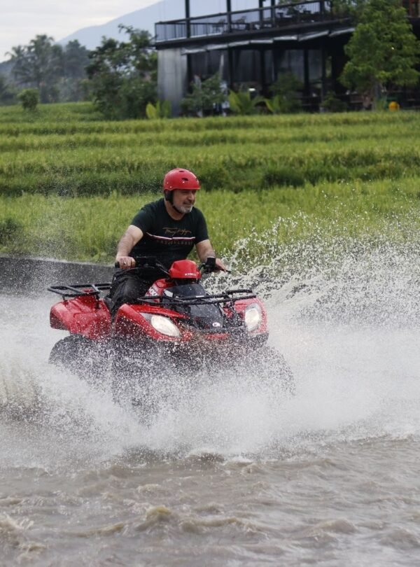 Experience the excitement of ATV riding through Bali's lush rice fields and splashing waters.