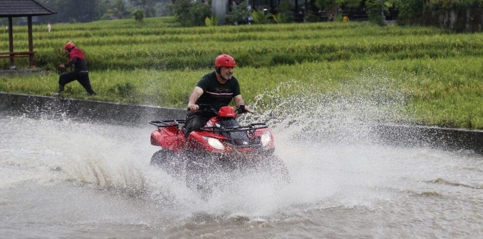 Experience the excitement of ATV riding through Bali's lush rice fields and splashing waters.